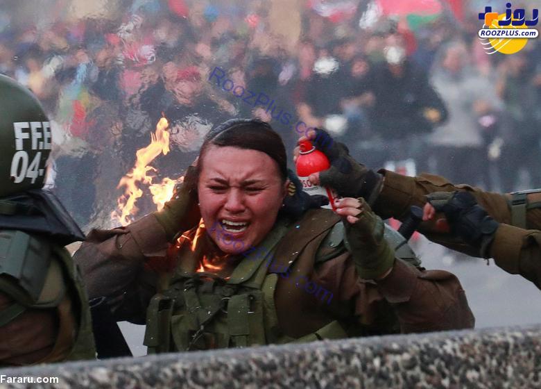 عکس/افتادن آتش به جان زنان پلیس شیلی